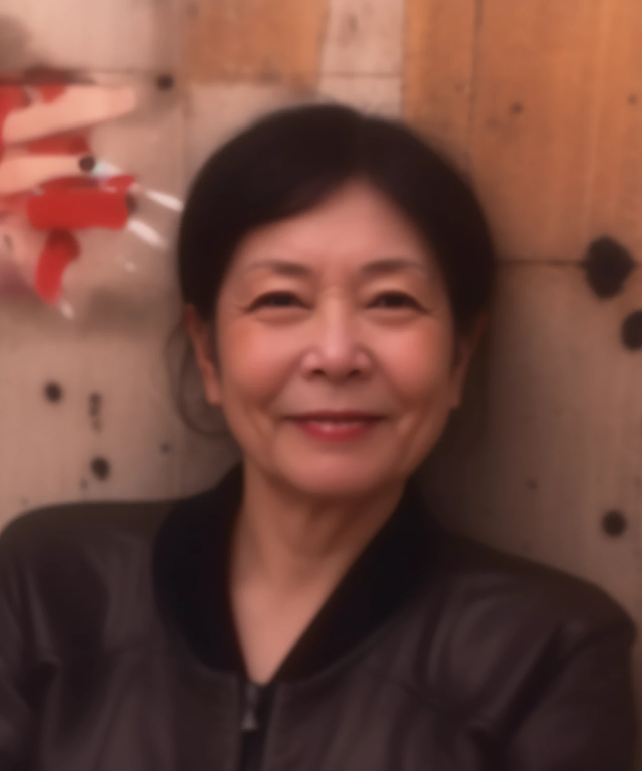 Smiling woman wearing a black jacket sitting in front of a wall, Riyoko Ikeda, Kiyoko Suzuki、etsuko miura, Sachiko Miyazaki, itsuko azuma