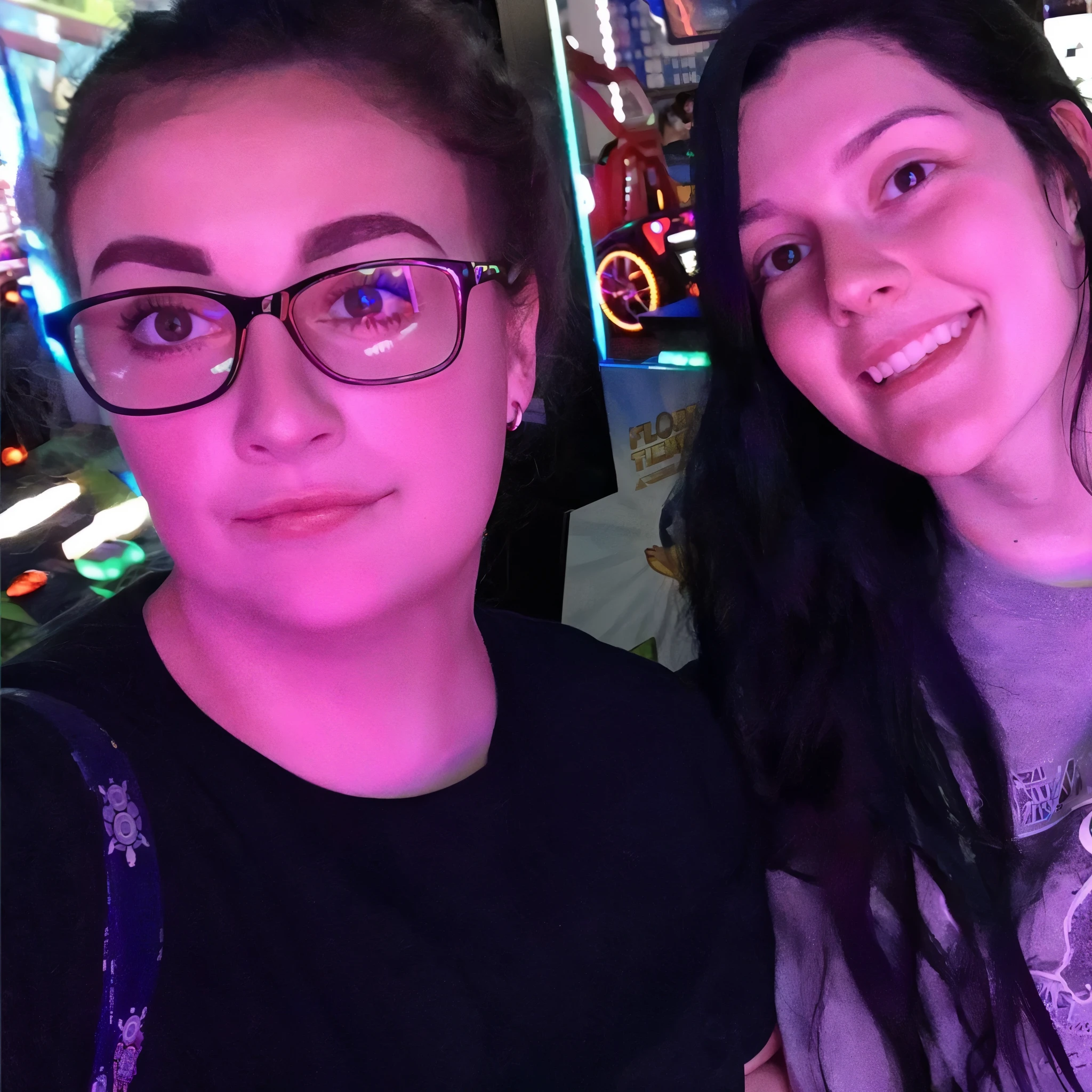 two women are posing for a picture in front of a game machine, charli bowater and artgeem, profile picture 1024px, profile pic, leslie david and lisa frank, taken in the early 2020s, vacation photo, both smiling for the camera, snapchat photo, alex yanes and lisa frank, facebook post