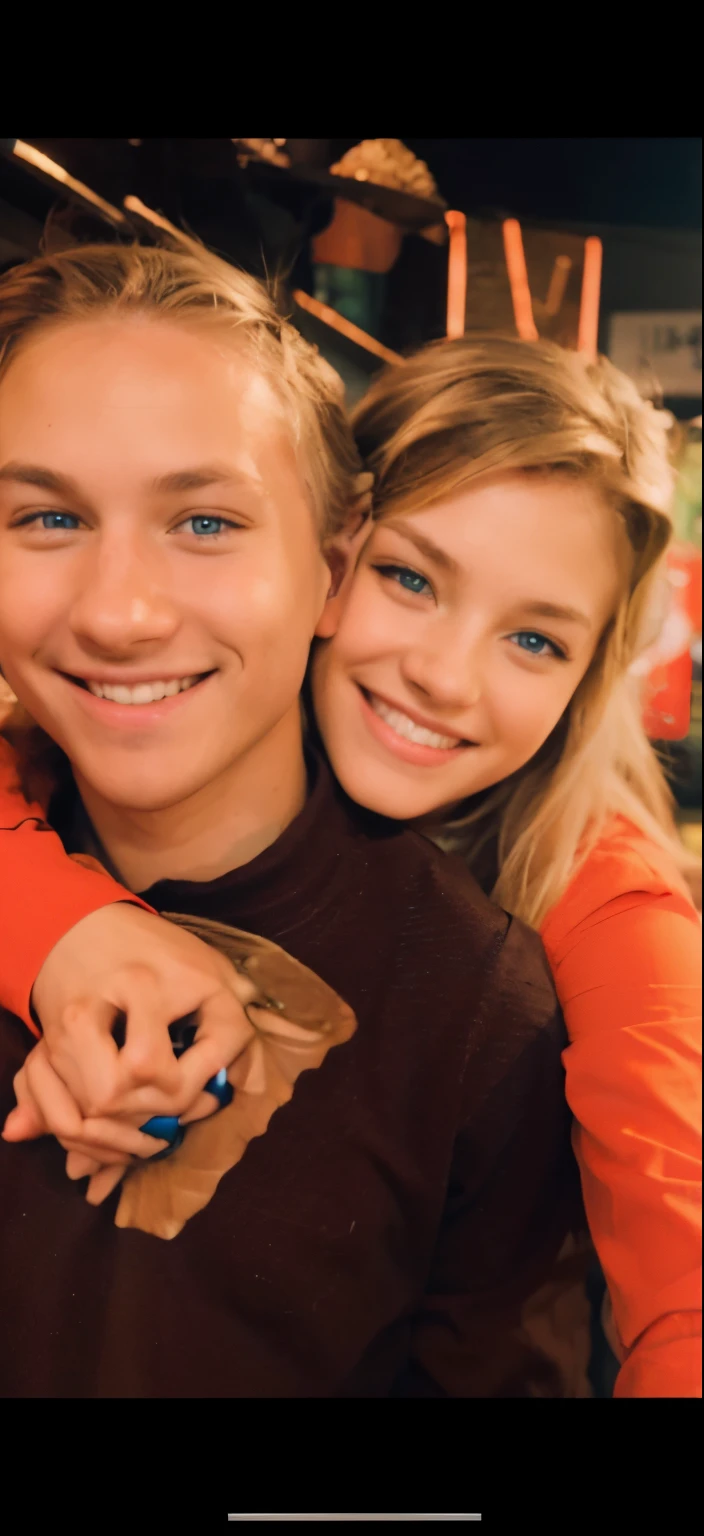 Smiling girl with blonde hair and blue eyes. Smiling boy with brown hair and brown eyes