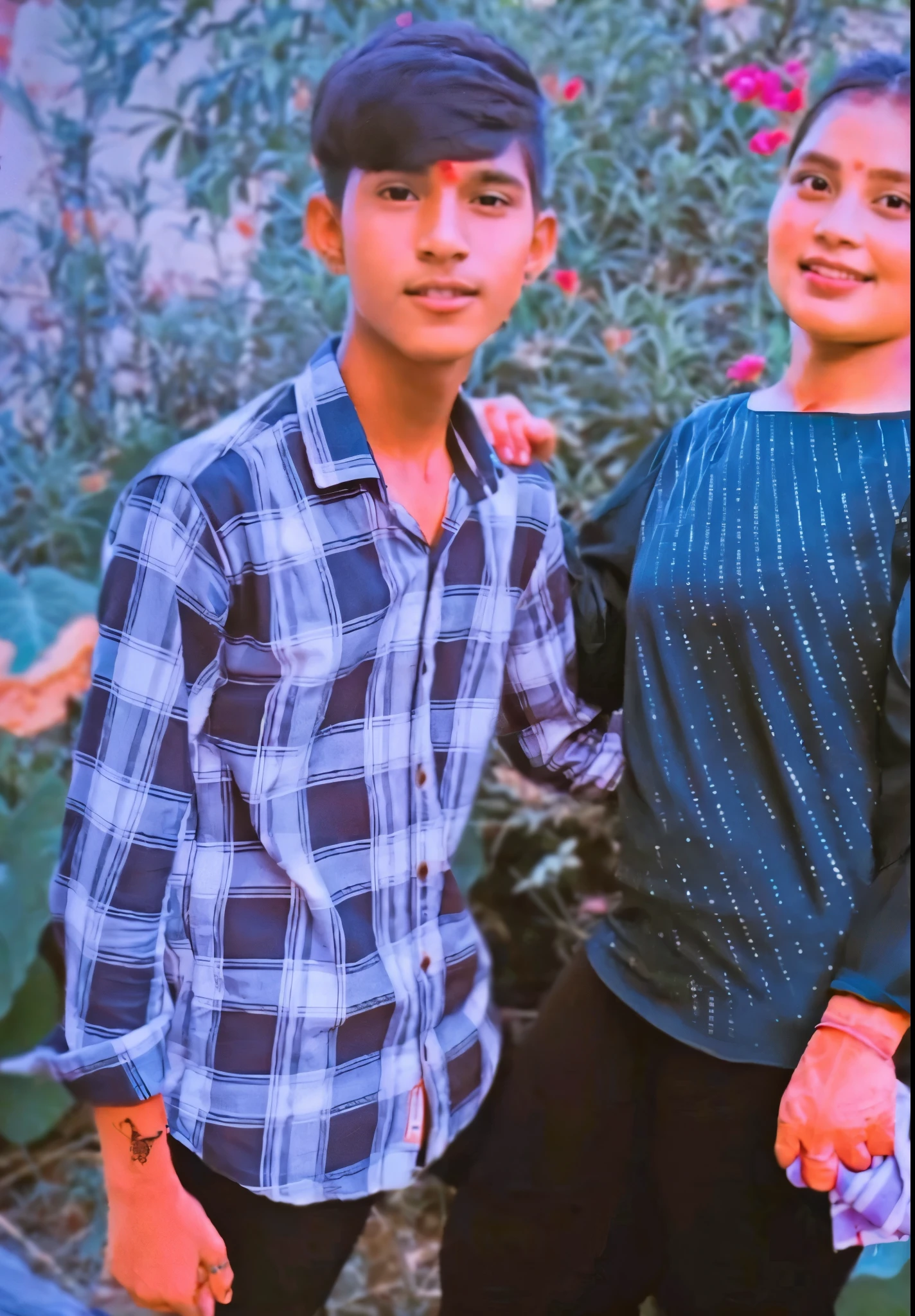 there are two people standing next to each other in a garden, ((oversaturated)), profile pic, photo taken in 2 0 2 0, profile image, profile photo, very very low quality picture, edited, profile picture, candid picture, colored photo, taken in the early 2020s, grainy low quality, ❤🔥🍄🌪