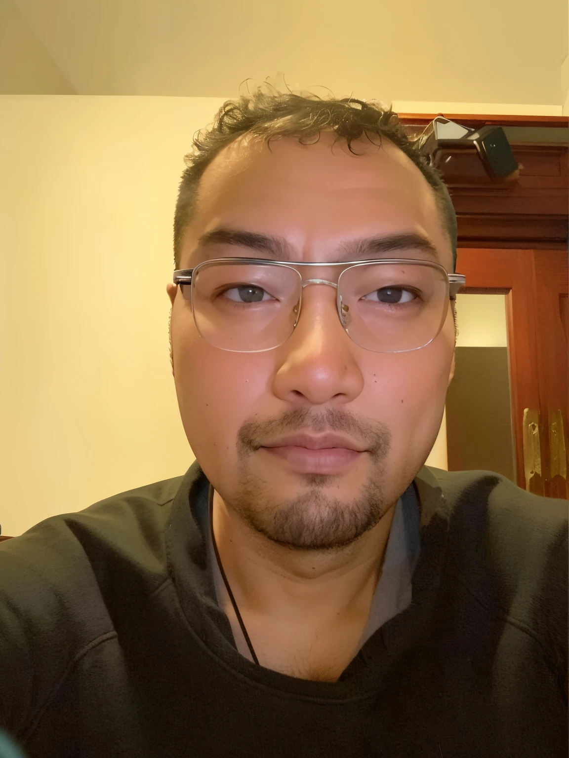 There is a man wearing glasses and a black shirt looking at the camera, 3 2 - year - old,  Shaw Peter