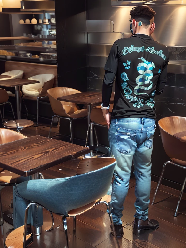 man standing in a restaurant and is wearing blue jeans black shirt