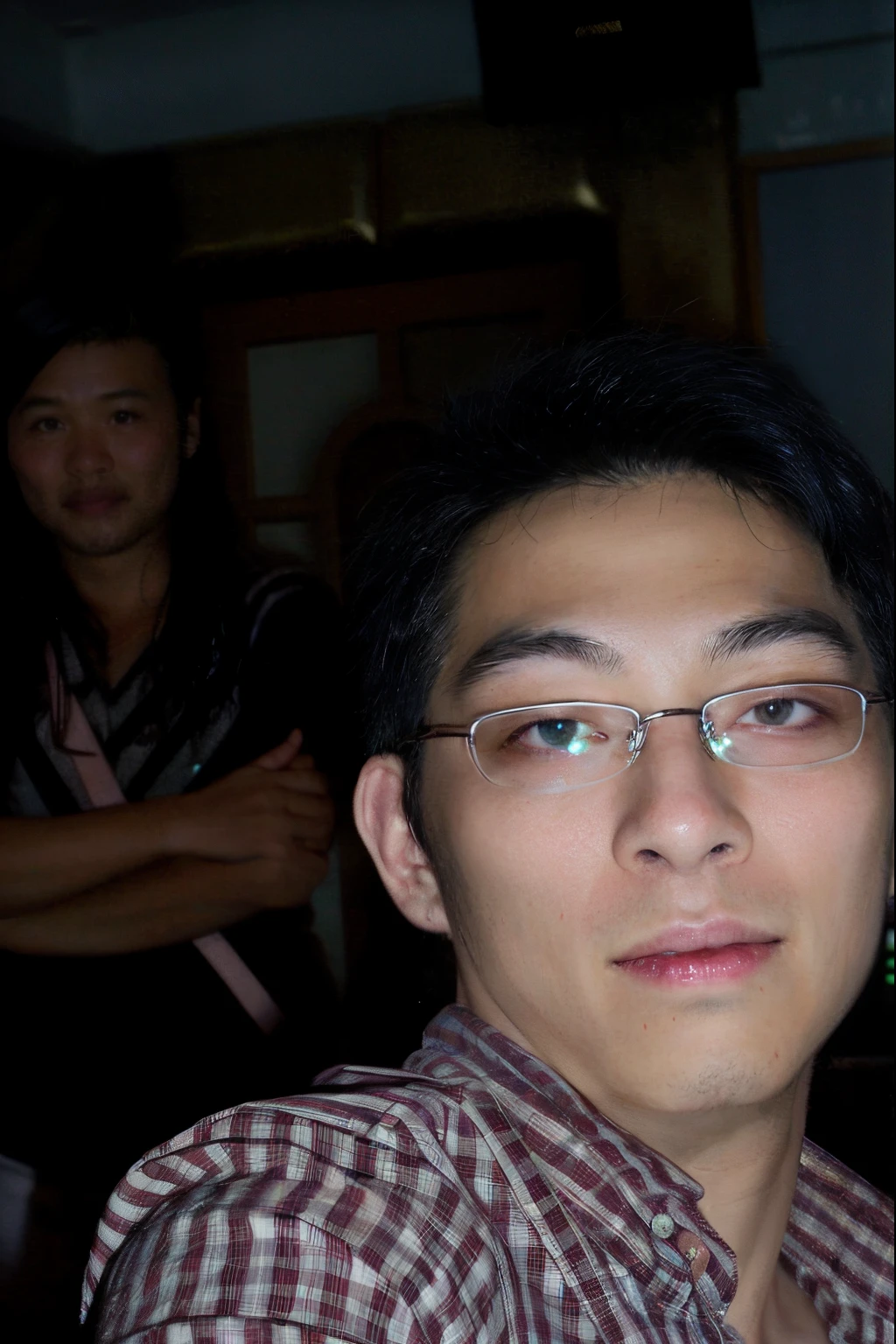 Man wearing plaid shirt posing for photo, ruan jia and brom, Photographed with camera flash, Distorted photos, with nerds! eye glass! and goatee, obscured face, Look at the camera intently, Weird portrait angle, photore ( far _ shooting ), fujicolor with flash, Shoot with the best DSLR cameras
