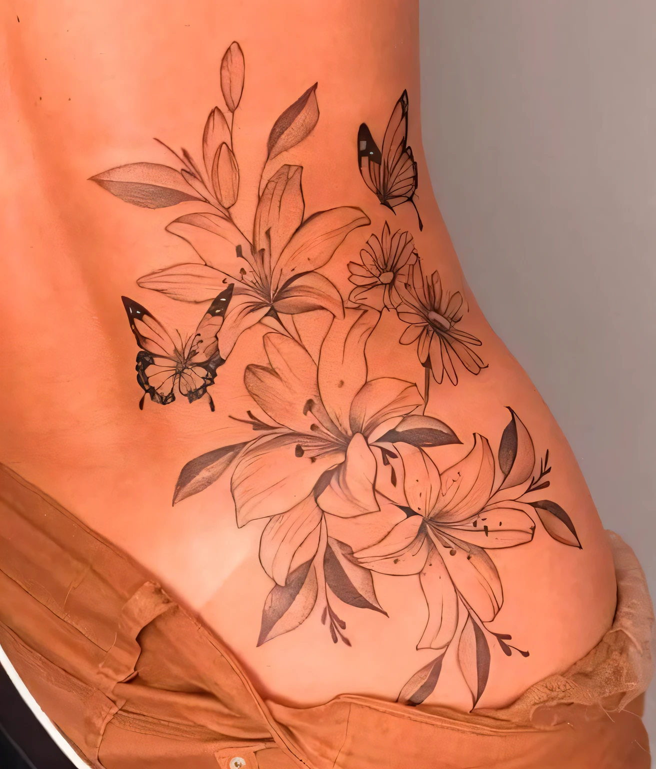 a close up of a woman's stomach with a tattoo of flowers and butterflies, body covered in floral tattoos, lower back of a beautiful, ink on skin, with colored flowers, floral tattoos, tattoos all over the skin, inking on skin, back tattoo, beautiful and realistic, flowers and butterflies, shaded tattoo, lower back, ultra - realistic and intricate