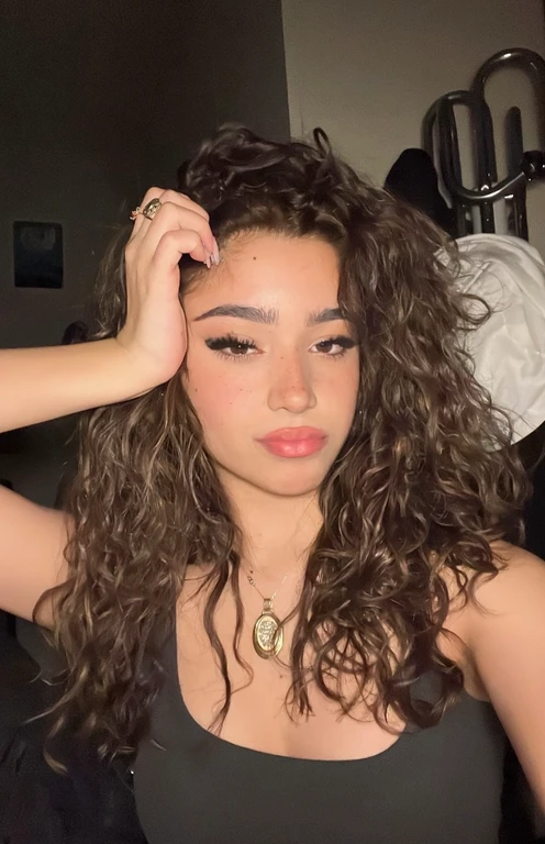 there is a woman with long curly hair and a necklace, messy curly hair,