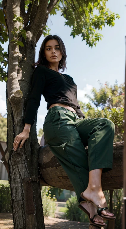 A woman with clothes a black shirt green pants and flip-flops she is climbing a tree