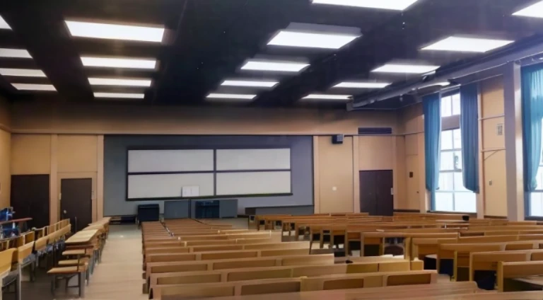 A large room with many people sitting on a row of chairs, typical anime classroom, anime scene, classroom in background, sitting in classroom, kyoto animation still, Lecture halls and venues, in class room, anime yulu camp, School Classroom, In the anime, Madhouse Studio anime style, in the anime film, anime movie scene