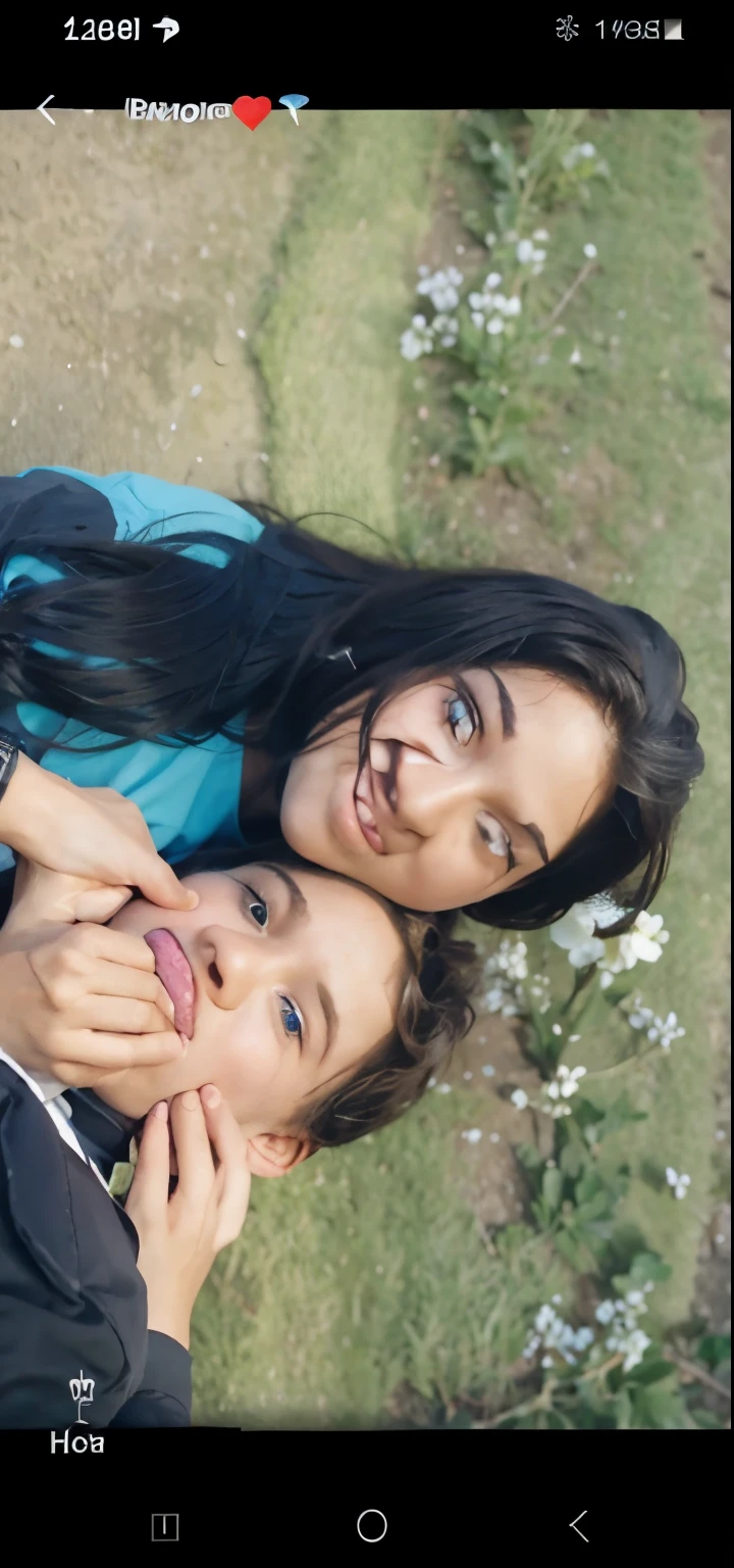The boy and girl qre lookinh sute the girl hand is in the boys faces
