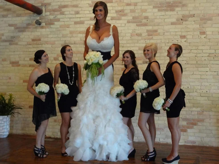 white wedding dress, (gigantic sagging breasts:1.4), (colossal breasts:1.4), cleavage, black cummerbund