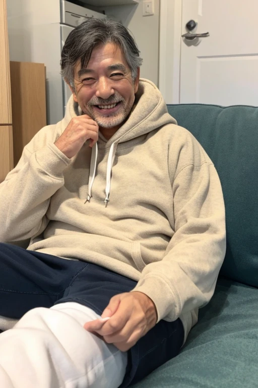 Looking at the smartphone and smiling,Handsome Japan,man in his 50's,I have a smartphone,wearing hoodies,Have a tan,lying on a futon in the room,White Room