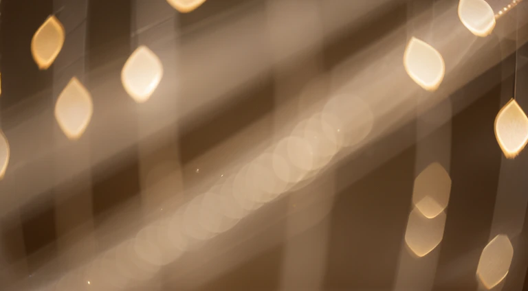a detail shot of a softly lit, abstract bokeh pattern, showcasing the delicate and sparkling lights as a soft and magical background.