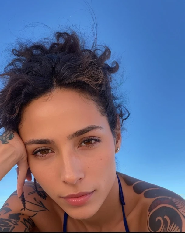 There is a woman with tattoos on her arms and chest, Mulher de 30 anos de Cuba, sem maquiagem, imagem de perfil, Malika Favre, selfie de uma jovem mulher, ao sol, sem maquiagem cabelo ondulado, zoë kravitz, taken in the early 2020s, pele banhada pelo sol, foto de perfil, em uma praia