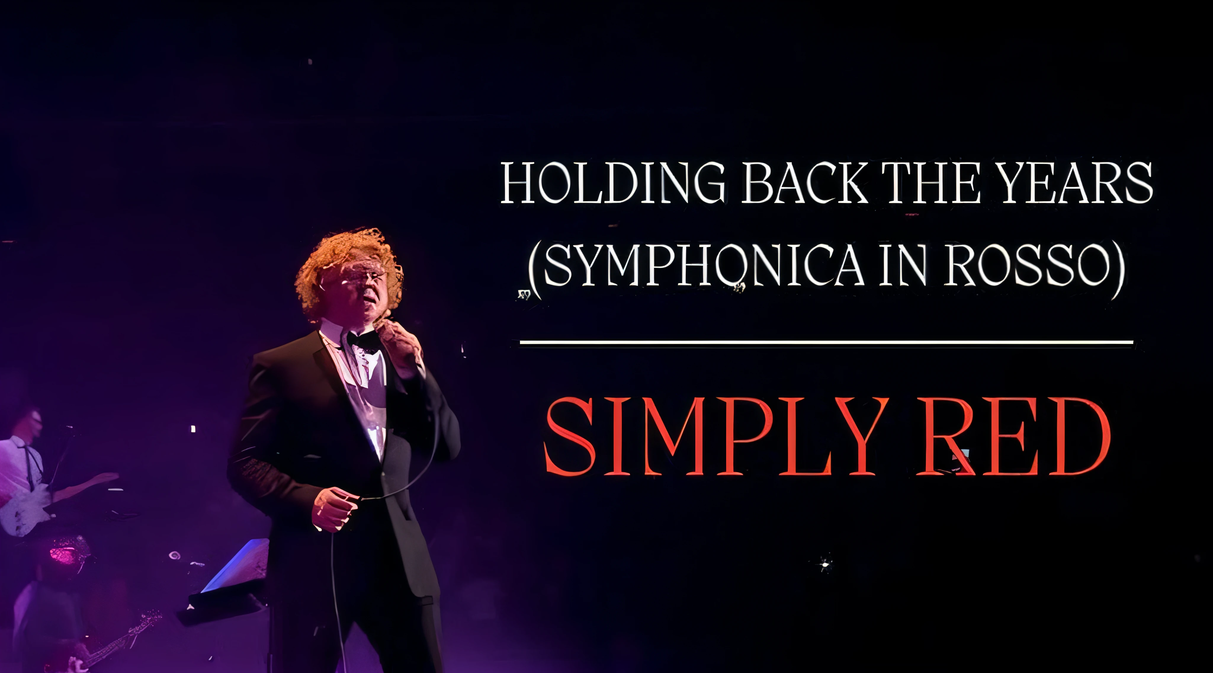 arafed image of a man in a tuxedo singing into a microphone, symphony, slightly turned to the right, smooth in _ the background, taken in the early 2020s, symmetrically, sympathetic, since, nostalgic, holding a pudica pose, photo from the back, finally, simplicity, with his back turned