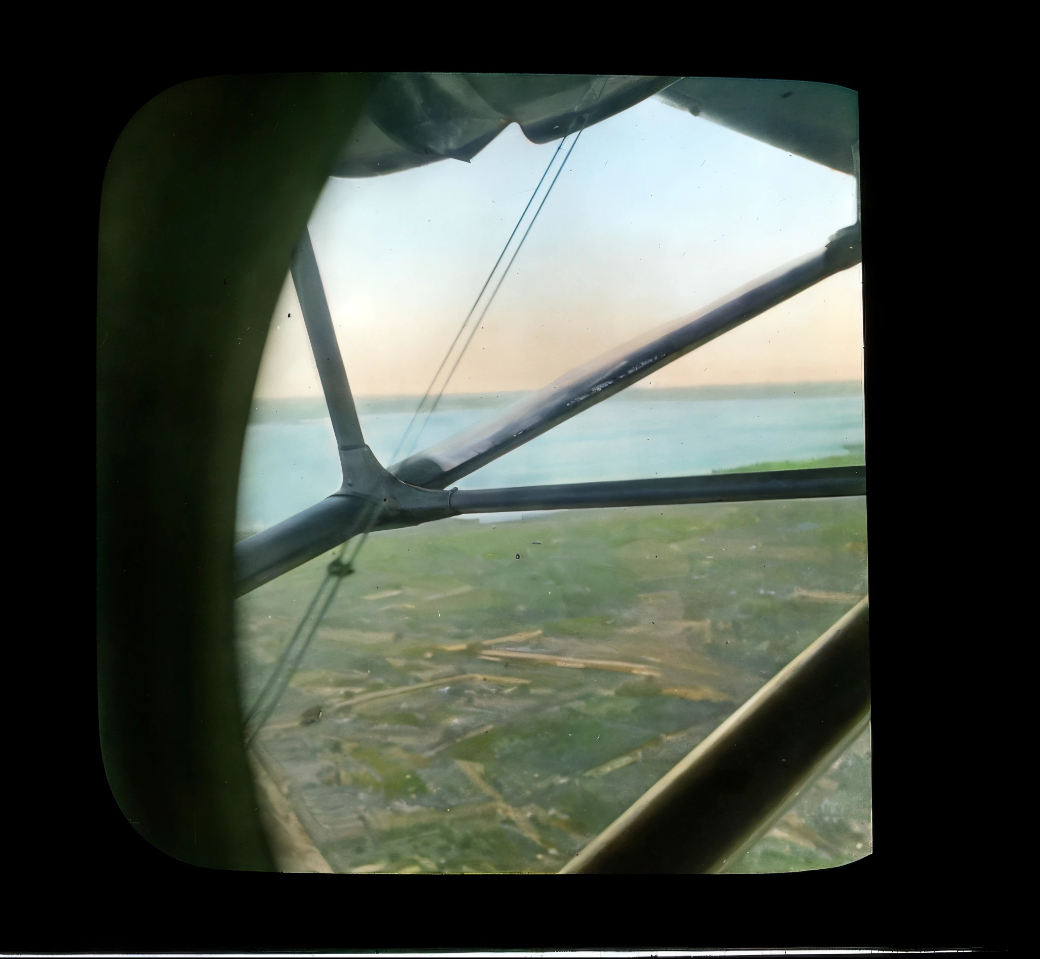 there a view of a field from a plane window, view from helicopter, cockpit view, scenic full shot, airborne view, seen from straight above, old color photograph, distant shot birds eye view, helicopter view, plain view, airplane window view, colorized, ( ( photograph ) ), viewed from bellow, 1 9 1 4, 1914