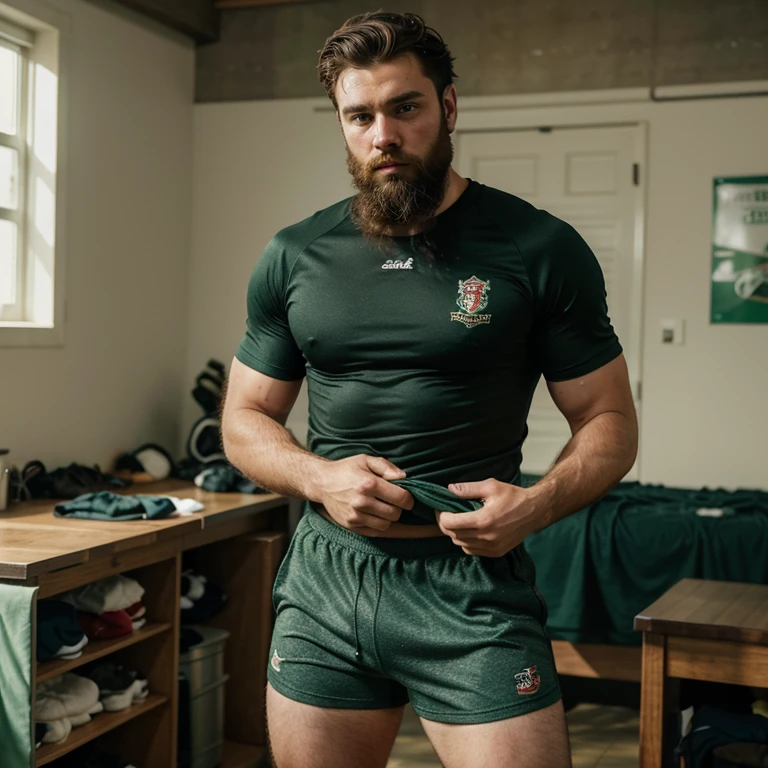 Realistic young man, very hairy, wearing rugby shorts and socks, sweating, bearded, brunet, green-eyed. He holds his sports t-shirt in his left hand.