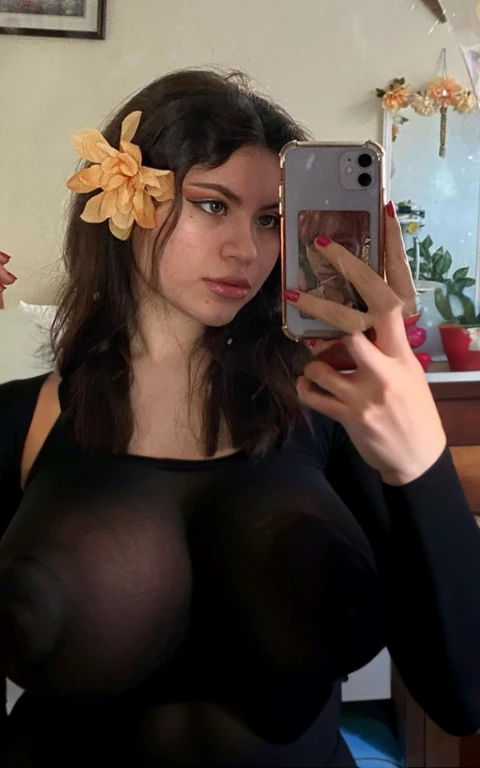 there a woman taking a selfie with her cell phone, wearing a flower headpiece, flower in hair, flower in her hair, headshot profile picture, floeers in hair, with flowers, flowers in hair, selfie of a young woman, very very low quality picture, flowers on hair, exotic lily ears, kailee mandel, lily frank, Huge tits, big breasts, huge breasts, giant breasts, saggy breasts, huge nipples, big areolas, sexy, tight top, see through top, hard nipples, nipples showing through top, cute, put breasts there
