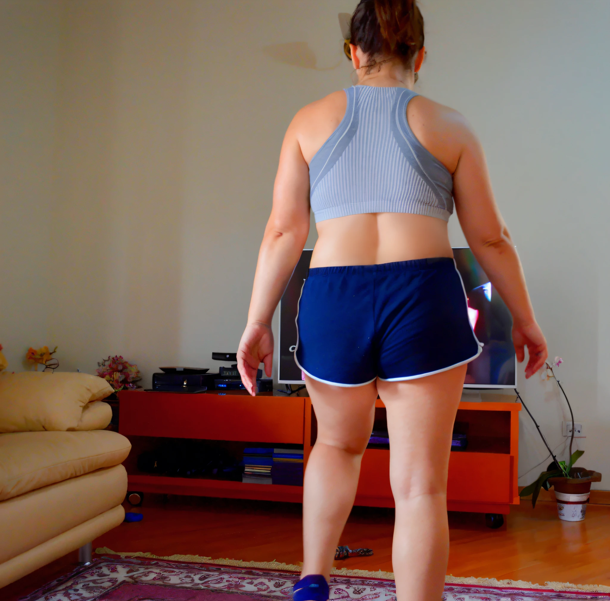 there is a woman standing in a living room playing video games, tiro longo das costas, sport bra and shorts, sport bra and dark blue shorts, Costas - Pneu, tiro longo de costas, tiro nas costas, tiro traseiro, Back from Toned, from the back, tiro pelas costas, seen from back, Tiroteio costeiro, medium shot taken from behind