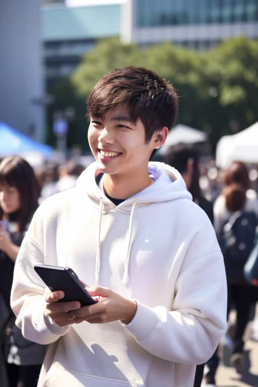 A 20-year-old Japanese man smiles while looking at his smartphone.,There are a lot of people at the idol live venue.,Wearing a white hoodie