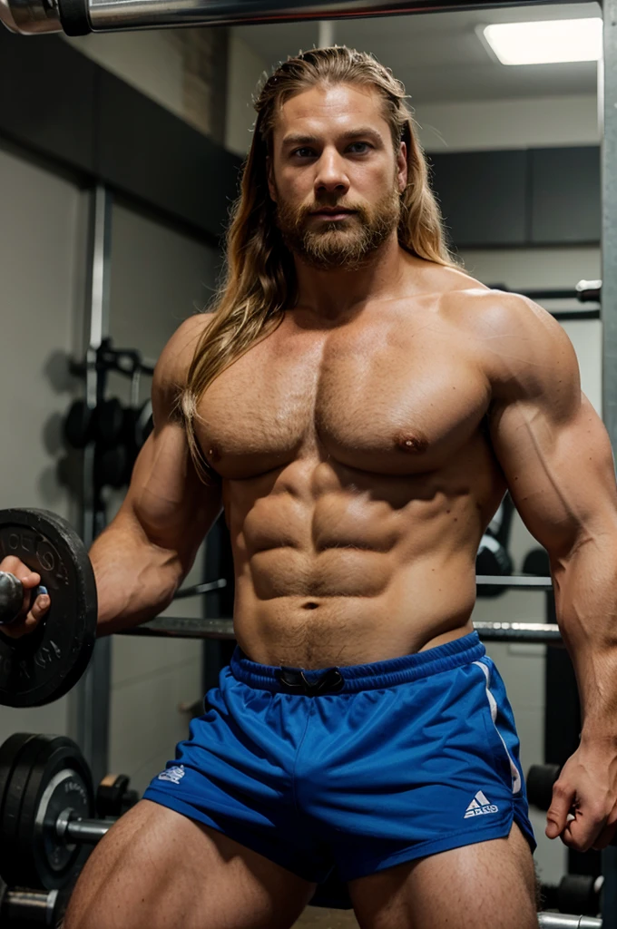 Man in the gym wirh big muscles, blonde hair like vikings, blue eyes and beard looking like thor doing heavy benchpress exercise