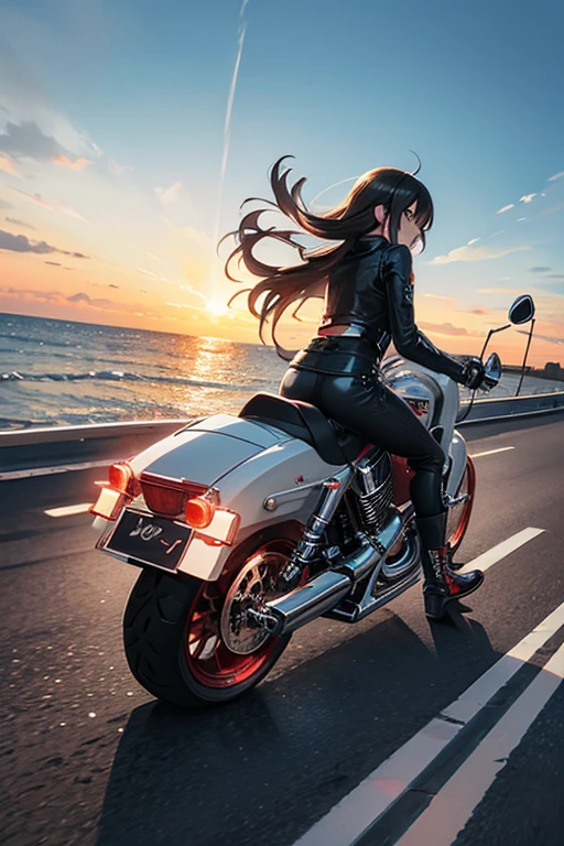 A Harley motorcycle is cruising on the highway, by the seaside, during sunset, capturing a sense of speed.