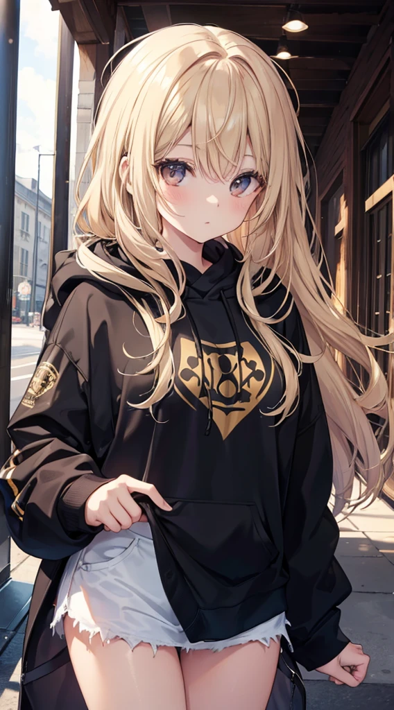 A Beautiful Young Woman with sun dappled skin Dirty Blonde hair and Deep Brown eyes wearing a black hoodie