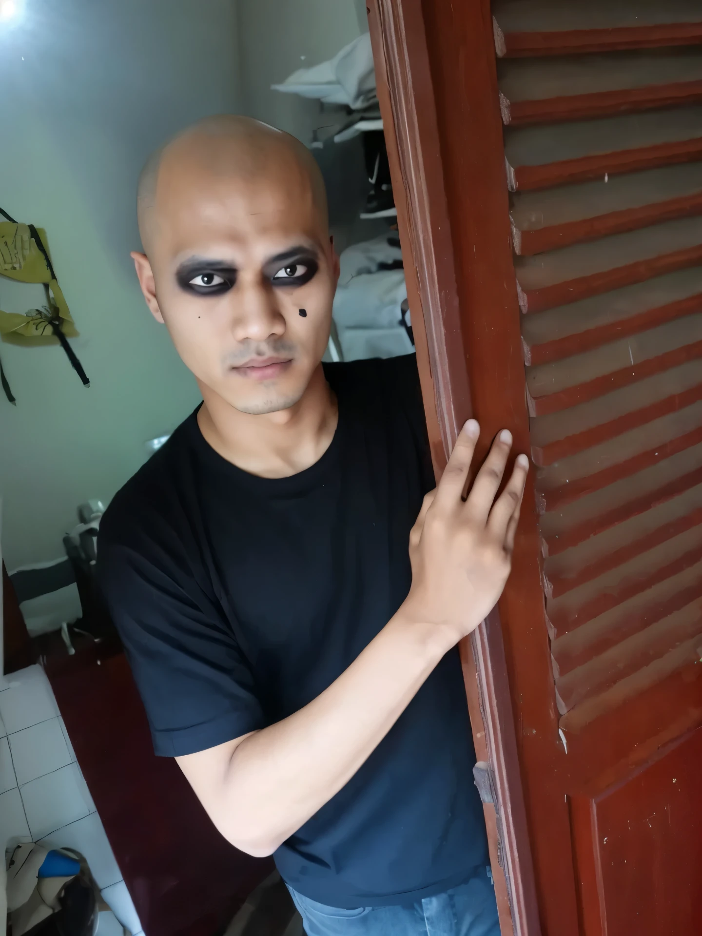 arafed ugly Chinese man with bald head and black eye make up peeking out of a door, scary look, 1 7 - year - old boy thin face, with black sclera eyes, shaven face, emaciated shaved face, black eyes and large forehead, shaved face, heavy make up, showing forehead, heavy makeup, shaved head, buzzed hair on temple, very dark skin, very small eyes, ((very small eyes))