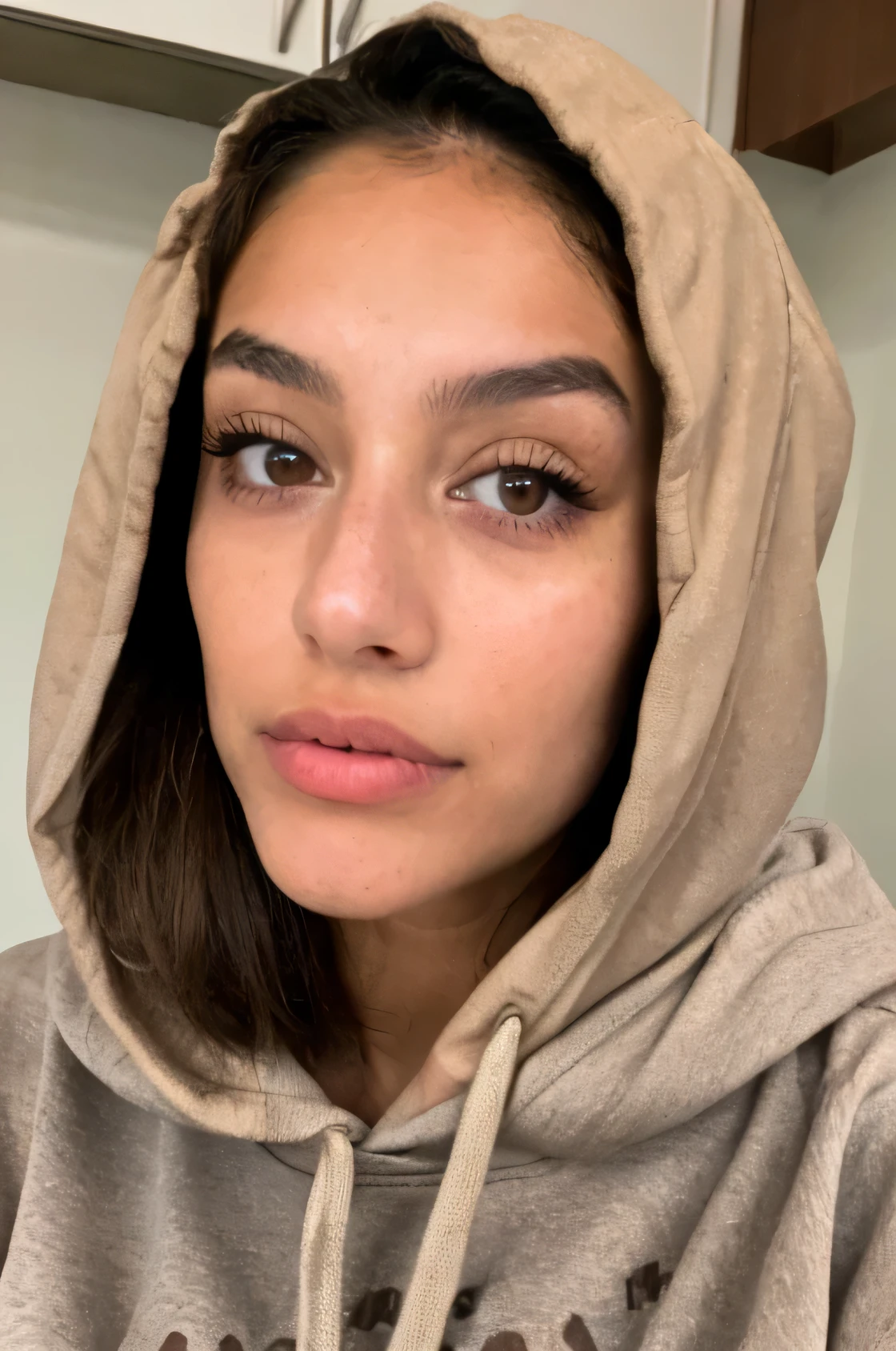Thin Latina model with light brown eyes , and clear brown wolfcut hairstyle with baggy cloth and a hoodie