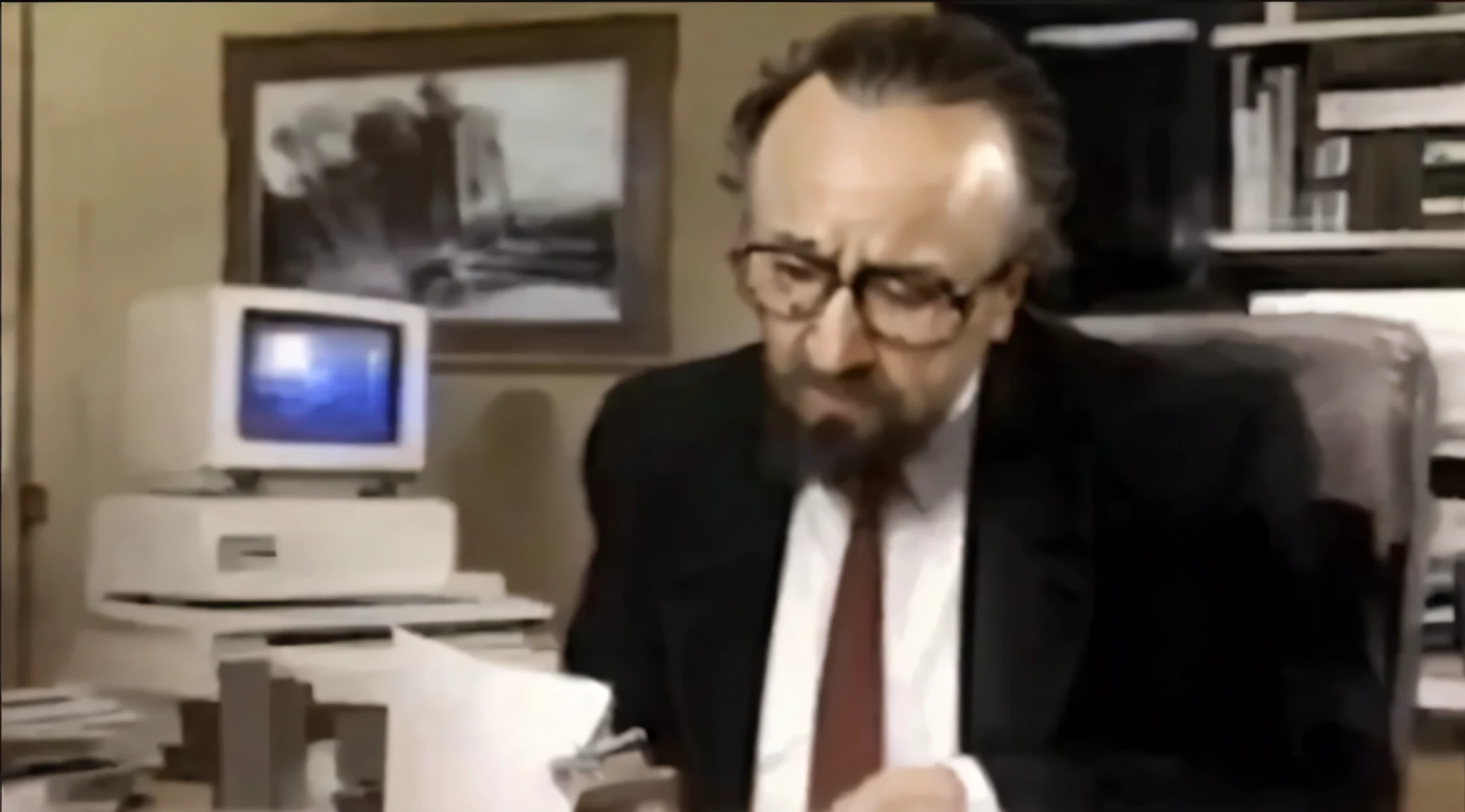 There is a man in a suit sitting on the chair, 1985年的videotape, video static, msotho, Rupert Murdoch as the Devil, 1 9 8 0 s analog video, old footage, Since 1986, videotape, Rob Schneider is a stapler, Ernest Gary Gygax face