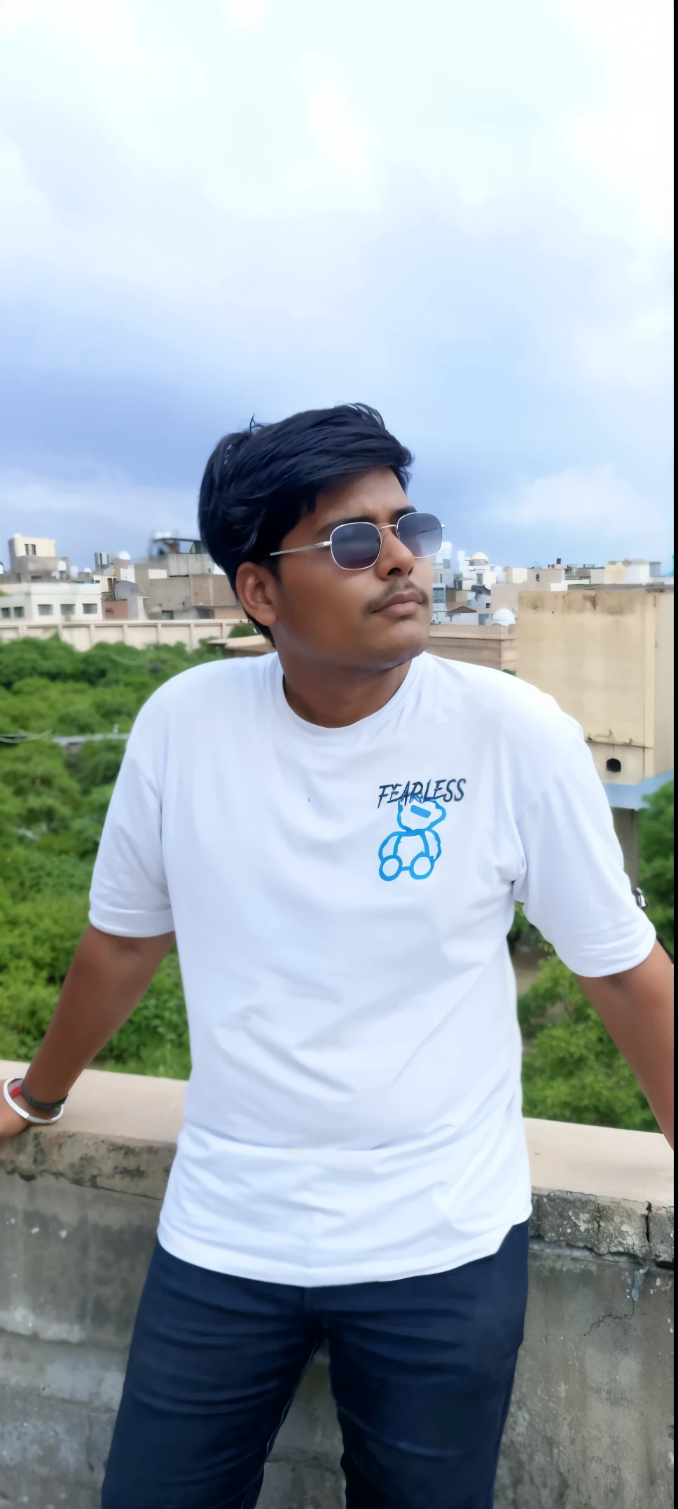 there is a man standing on a ledge with his hands on his hips, in tshirt, jayison devadas, with accurate face, with a cool pose, profile pic, wearing a t-shirt, without helmet, jayison devadas style, stylish pose, wearing in shirt, candid picture, marvelous expression, tshirt, portrait mode photo, taken with sony alpha 9, change the clothes with a puffer jacket and a white t shirt inside