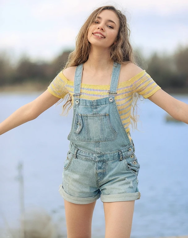 skinny blonde girl in short dungarees in the park, seductive, attractive, small breasts, petite, skinny, age body