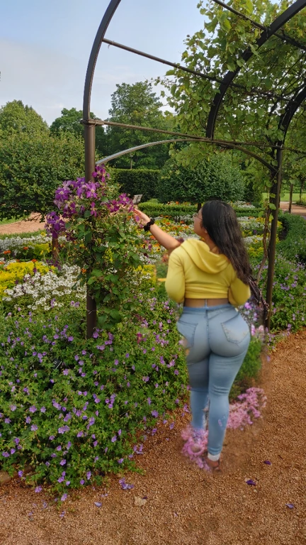 woman in yellow shirt standing in a garden with flowers, standing in a botanical garden, standing in flower field, standing in a flower field, picking up a flower, parks and gardens, picking flowers, girl standing in a flower field, ancient garden behind her, girl in flowers, walking at the garden, flower garden, photo taken with canon 5d, there is a woman standing in a doorway looking up at something, wearing a pastel pink hoodie, standing in an alleyway, wearing a pink hoodie, stood in a tunnel, leaning on the wall, leaning against the wall, photo taken with canon 5d, distant full body shot, taken with a canon eos 5d, taken with a canon eos 5 d, Big tits, huge tits, no clothes, sexy, cute, wide hips, thick thighs, pear-shaped body, minimal clothes, thick, bbw, chubby stomach, thick nipples, nipple piercings, large areola, hard nipples, piercing through shirt, nipples hard through shirt, busty, major cleavage, naked, ripping through top, boobs spilling over sides, bra too tight, giant tits, giant ass, from side, side boob, side view, huge ass sticking out, panties too small to contain, ass from behind