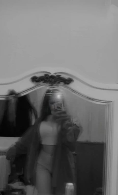 (Best quality, Ultra-detailed, Masterpiece:1.5), beautiful pakistani woman taking a picture of herself in a mirror, The woman should have a flawless, highly detailed face, soft luminous . Her long hair should be naturally brown and stylishly arranged. (Perfect Eyes:1.2), double eyelids, photo-realistic:1.5), 8K UHD, high budget, unsettling image, inspired by Anna Füssli, a black and white photo, still from a music video, black and white image, a still of an ethereal, looking into a mirror, blurry, black and white picture,
