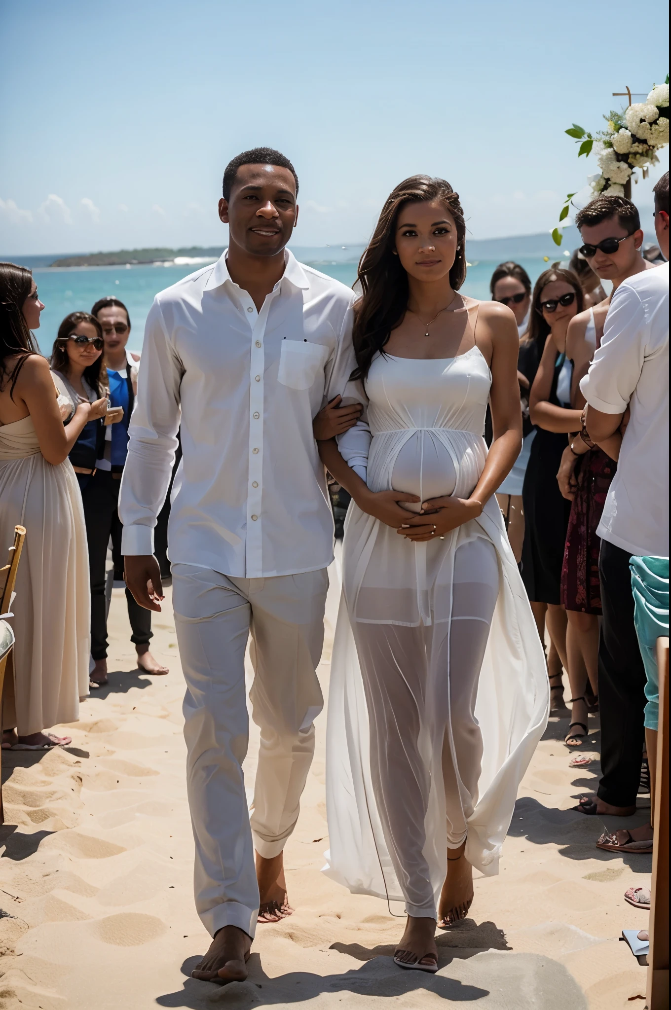 A black male groom walks along with a white-skinned pregnant bride with brown hair in a transparent white dress at a beach wedding ceremony