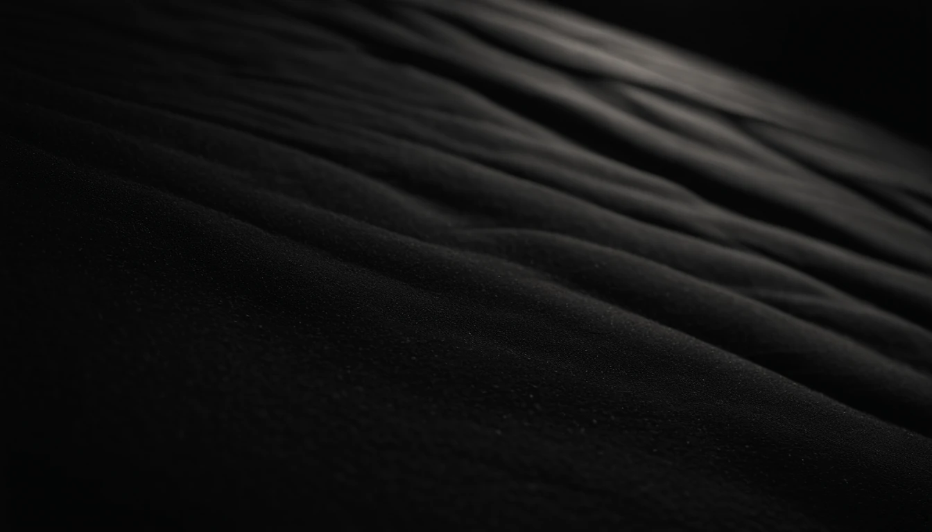a detailed macro shot of the texture of an empty black wall, focusing on the fine grain and subtle imperfections that give it character and depth