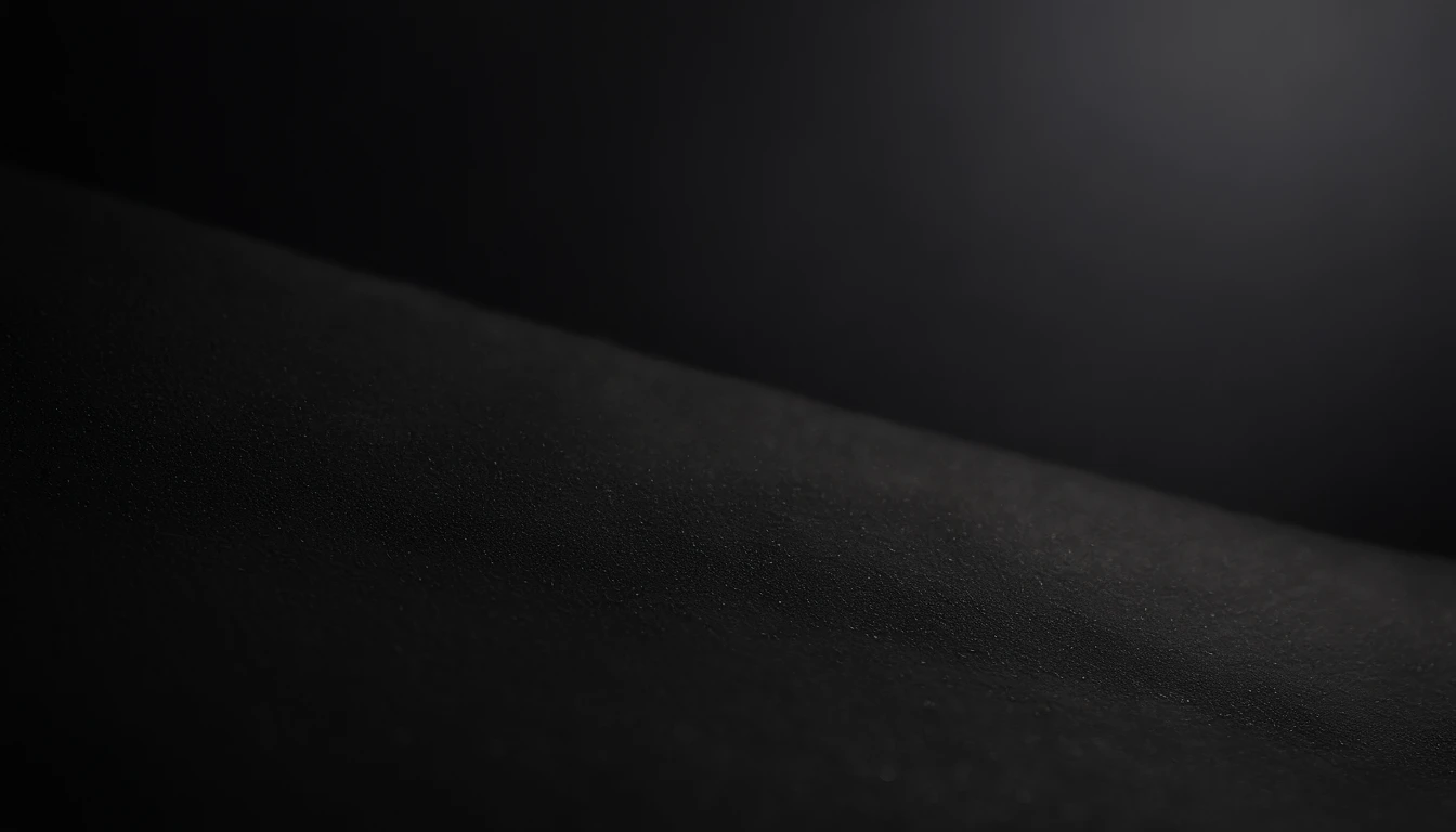 a detailed macro shot of the texture of an empty black wall, focusing on the fine grain and subtle imperfections that give it character and depth
