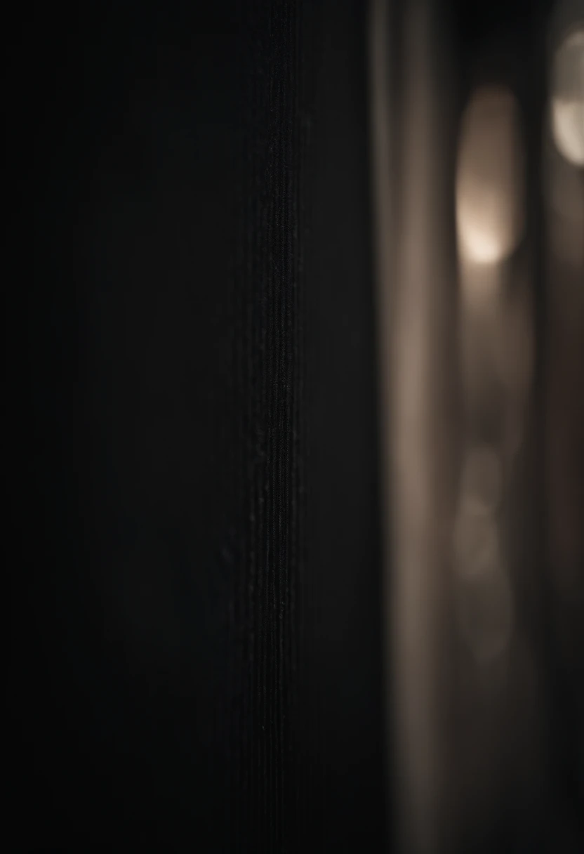 a detailed macro shot of the texture of an empty black wall, focusing on the fine grain and subtle imperfections that give it character and depth