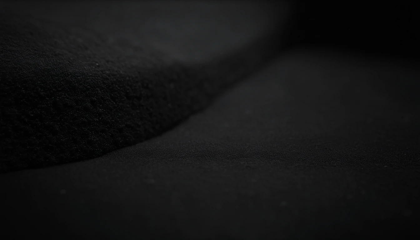 a detailed macro shot of the texture of an empty black wall, focusing on the fine grain and subtle imperfections that give it character and depth