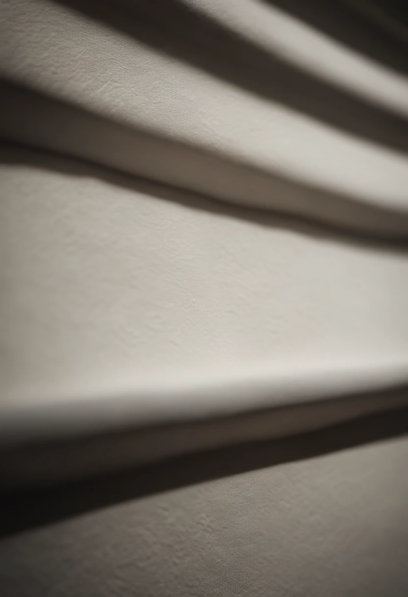 a detailed macro shot of the texture of an empty white wall, focusing on the fine grain and subtle imperfections that give it character and depth