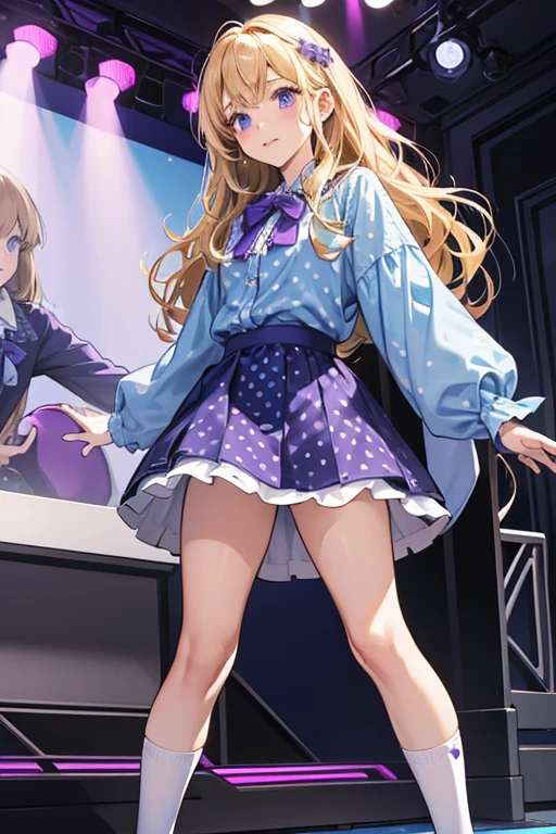 Patti has tanner skin and wavy blonde hair. She wears a blue long-sleeved shirt with purple polka-dots and purple trim, a dark blue short skirt, white socks, one of which is slightly shorter than the other and purple and white sneakers.