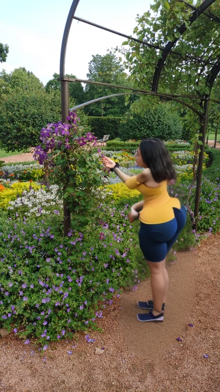 woman in yellow shirt standing in a garden with flowers, standing in a botanical garden, standing in flower field, standing in a flower field, picking up a flower, parks and gardens, picking flowers, girl standing in a flower field, ancient garden behind her, girl in flowers, walking at the garden, flower garden, photo taken with canon 5d, there is a woman standing in a doorway looking up at something, wearing a pastel pink hoodie, standing in an alleyway, wearing a pink hoodie, stood in a tunnel, leaning on the wall, leaning against the wall, photo taken with canon 5d, distant full body shot, taken with a canon eos 5d, taken with a canon eos 5 d, Big tits, huge tits, no clothes, sexy, cute, wide hips, thick thighs, pear-shaped body, minimal clothes, thick, bbw, chubby stomach, thick nipples, nipple piercings, large areola, hard nipples, piercing through shirt, nipples hard through shirt, busty, major cleavage, naked, ripping through top, boobs spilling over sides, bra too tight, giant tits, giant ass, from side, side boob, side view, huge ass sticking out, panties too small to contain, ass from behind