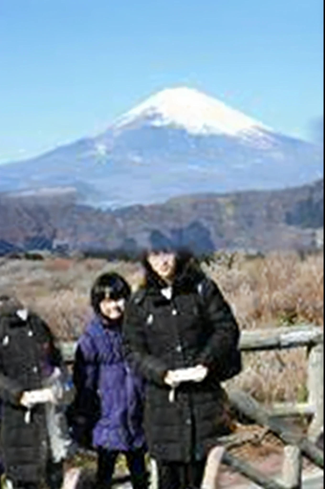 The Fede family stood on a bridge in front of the mountain, mount in the background, mt. , mount , in volcano, volcano in background, mount on the background, With volcano as background, japan sightseeing, goto ta, at snowy mountain sunrise, japan rural travel, standing close to volcano, vacation photo
