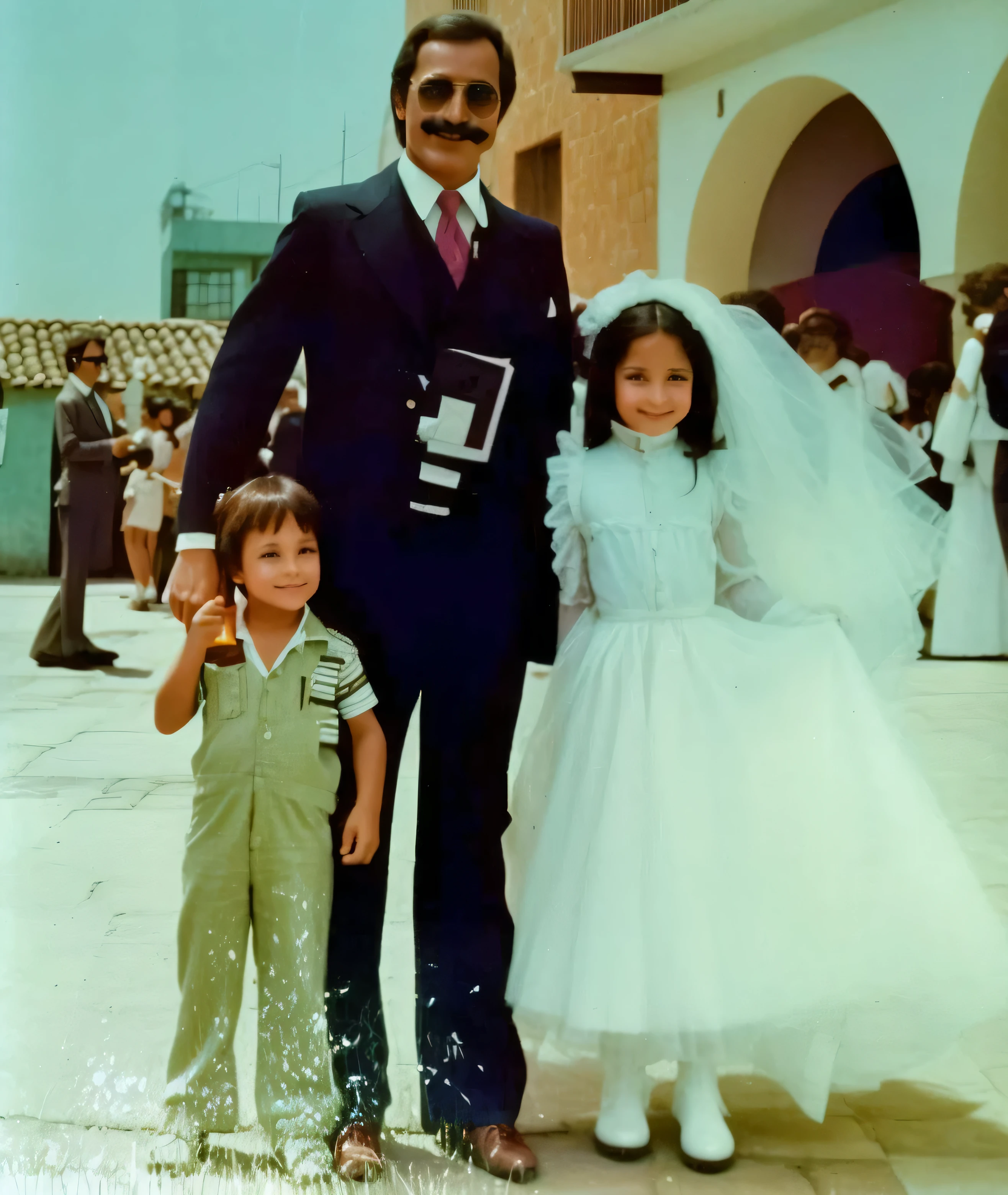 There are two  and a smiling man with dark sunglasses and a wispy mustache..,no epeso, parados en un patio, 1979, 1 9 7 9, 1977, 1 9 7 7, 1980, 1 9 8 0, 1 9 7 8, 1978, 1983, 1 9 8 3, boda, 1973, 1 9 7 3