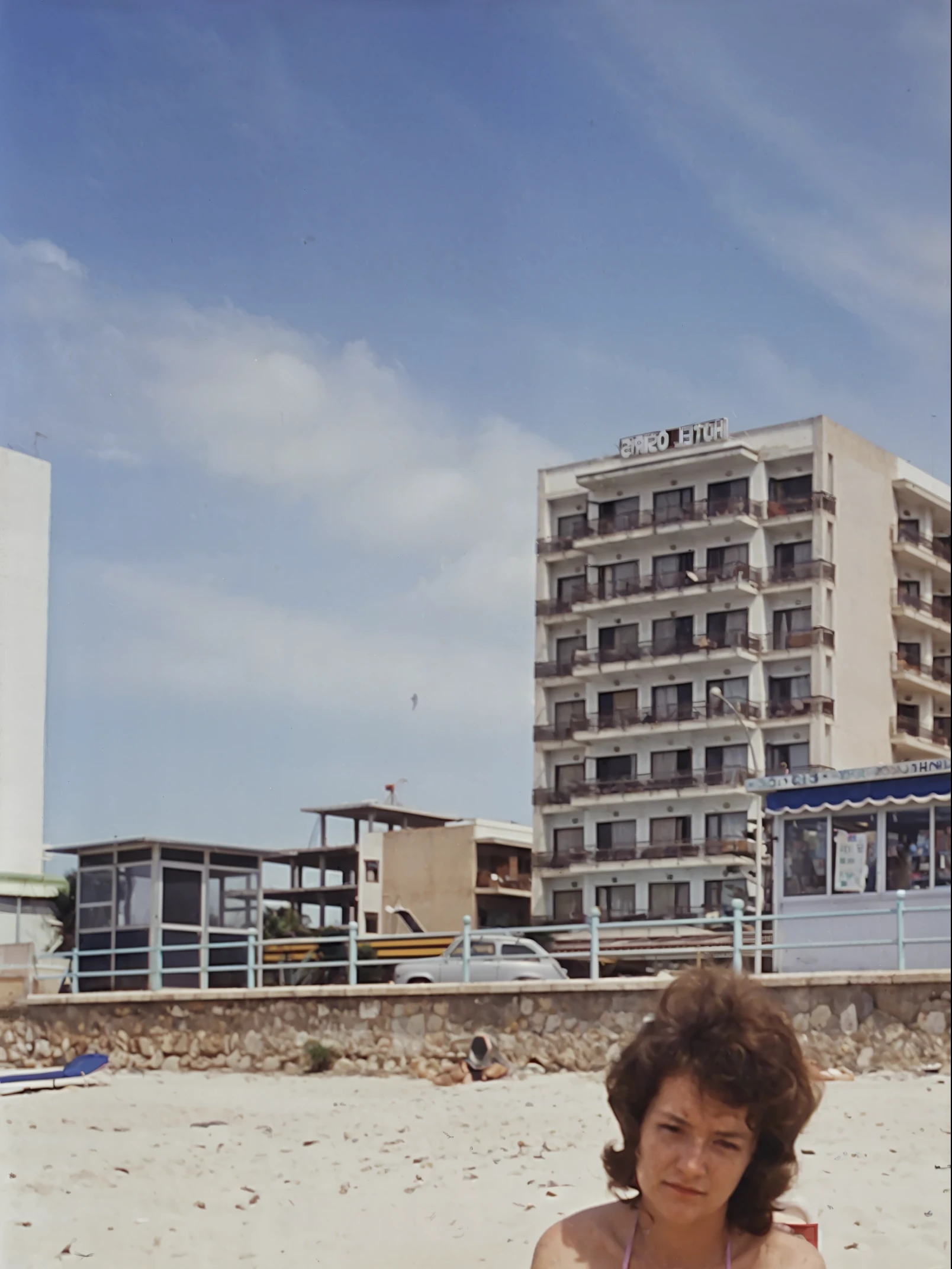 there is a woman sitting on a towel on the beach, martin parr, eighties photography, stephen shore, joel meyerowitz, 1980s photography, woman on the beach, sandra chevier, by Lee Loughridge, alexandra fomina, joel sternfeld, taken on 1970s kodak camera