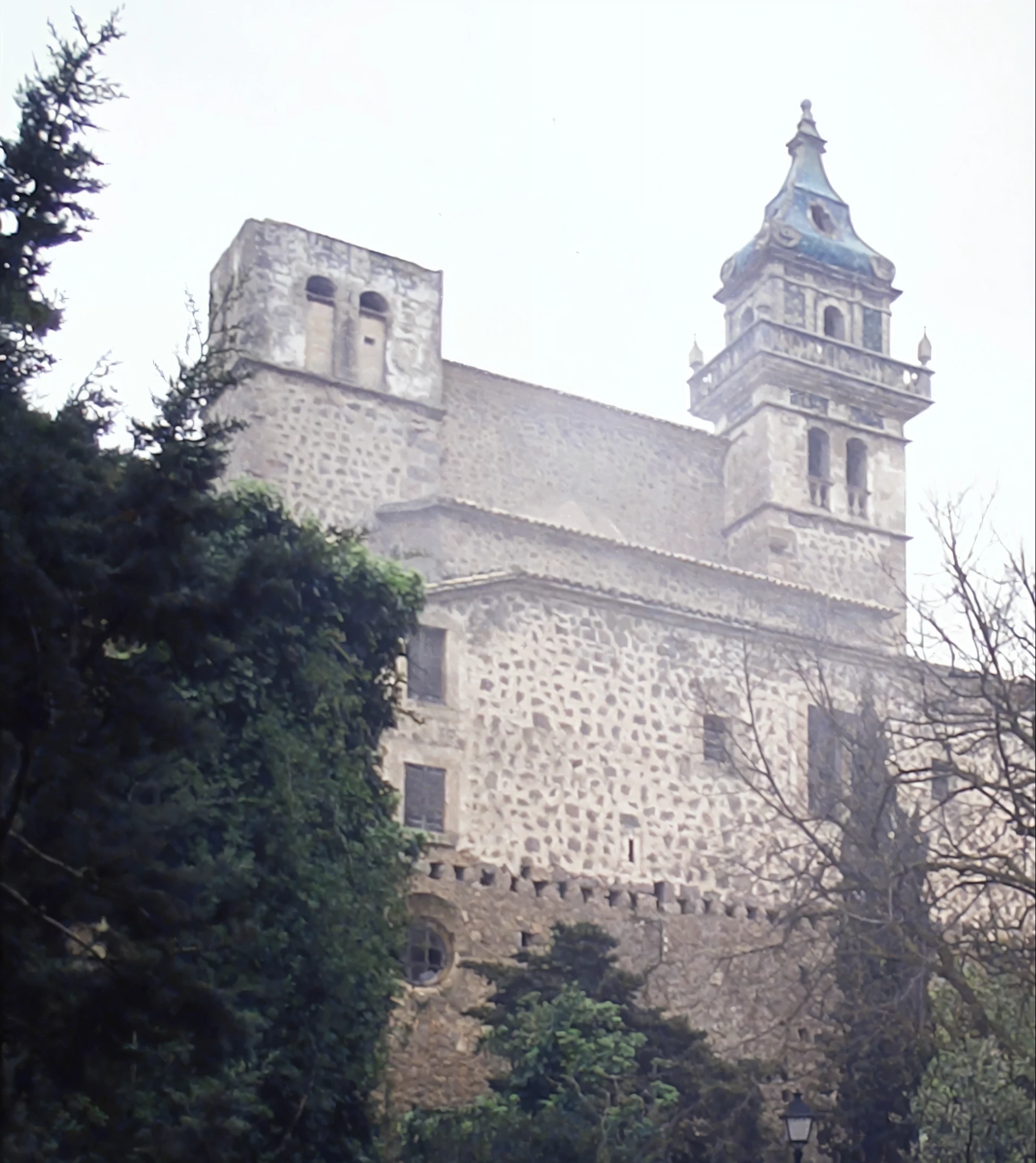 there is a large building with a clock tower on the top of it, monastery, monserrat gudiol, tlaquepaque, teruel city in ????, inspired by Luis Paret y Alcazar, the castle, old castle, old abbey in the background, castle, gothic baroque citadel, seen from a distance