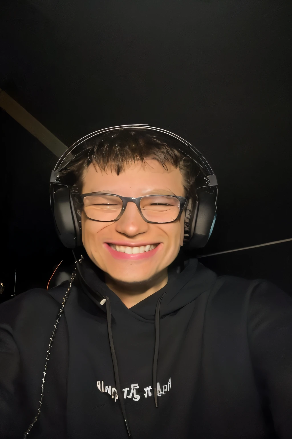 smiling boy wearing headphones and glasses with a black hoodie, twitch streamer / gamer ludwig, profile picture 1024px, headshot profile picture, bladee from drain gang, taken in the early 2020s, very slightly smiling, twitch streamer, very very low quality picture, halfbody headshot, discord profile picture, insane smile, he is smiling