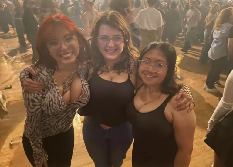 three women standing next to each other in a room full of people, non blurry, with tiny people, concert photo, not blurry, photo taken in 2 0 2 0, very grainy, very very low quality picture, profile pic, profile picture, very very low quality, by Bernie D’Andrea, photograph of three ravers, threesome, Big tits, huge tits, no clothes, sexy, cute, wide hips, thick thighs, pear-shaped body, minimal clothes, thick, bbw, chubby stomach, thick nipples, nipple piercings, large areola, hard nipples, piercing through shirt, nipples hard through shirt, chubby stomach showing, tummy spilling over the side, muffin top, the girls are sexy, short girls, only top of body, top zoom in, girl in middle behind