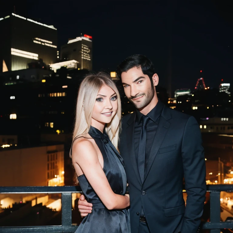 Tom Ellis and Taylor Momsen looking at eachother smiling calmly as they stand at the top of a rooftop building in Los Angeles at night, as they look into each others eyes laying on the rooftop railing. Taylor Momsen is wearing a black revelative dress, as Tom Ellis wears a black suit