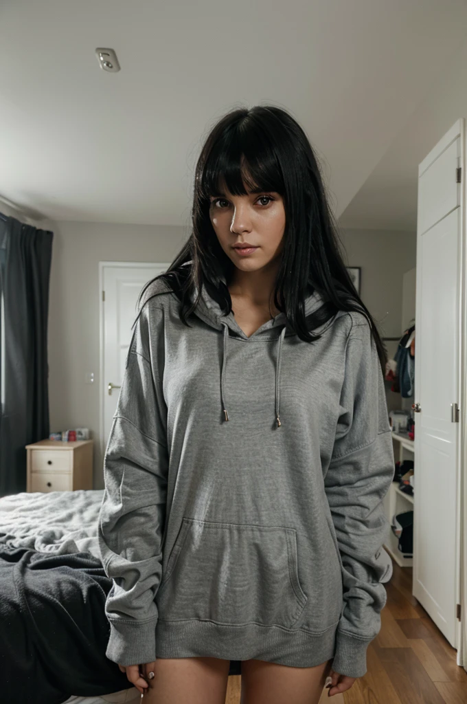 portrait photography of a white woman with black hair and bangs wearing a black skirt and a oversized long grey hoddie in her room