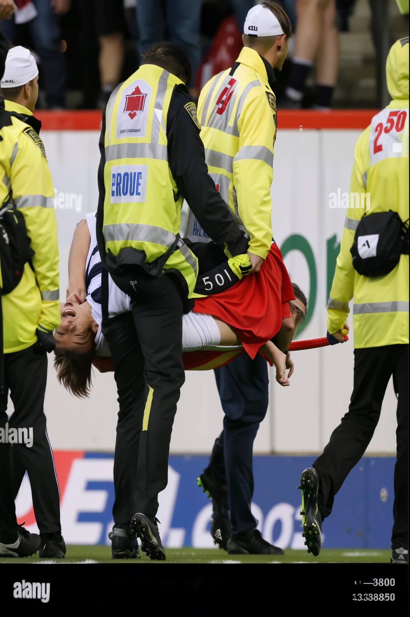During a soccer game, a man is carried off the field by emergency services, 513330673, Alamy Stock-Fotografie, 555400831, 3580780586, 3945074687, 3389861569