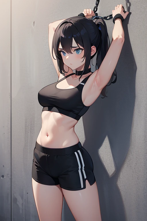 girl in black sports bra with hands chained to a wall